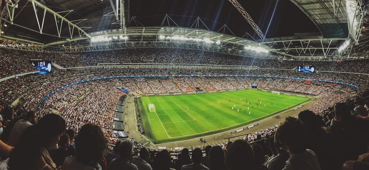 Packed stadium crowd watching a live football match